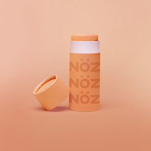 Colorful, reef safe, vegan Nöz sunscreen in a colorful orange hue